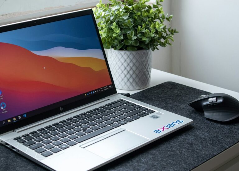A laptop open on a desk, part-way through building a website